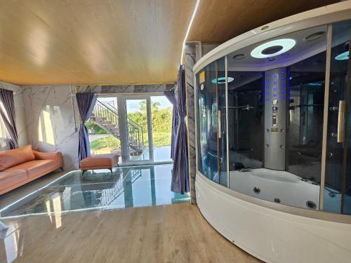 a living room with a glass floor and a tub at V A C Haven Viet Nam 2 in Phú Mỹ