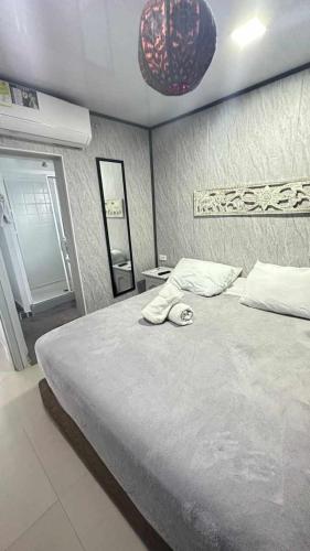 a bedroom with a large bed with a mirror at Le Castel Blanc Hotel Boutique in San Andrés