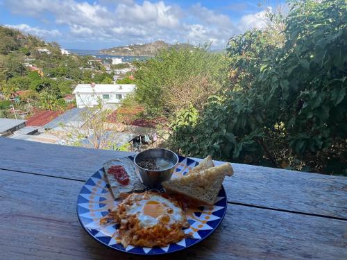 a plate of food on a table with a cup of coffee at Buena Onda Backpackers in San Juan del Sur