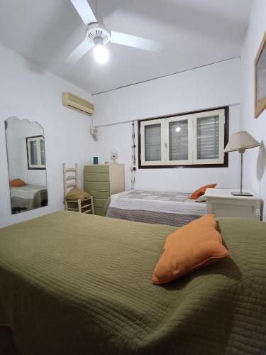 a bedroom with two beds and a ceiling fan at Casa Forum in Santiago del Estero