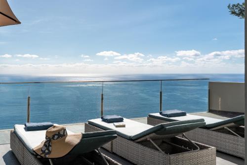 a balcony with chairs and a view of the ocean at Villa Harmonia by Homie in Ponta do Sol