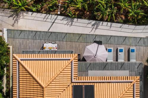 an overhead view of a wooden fence with an umbrella at Villa Harmonia by Homie in Ponta do Sol