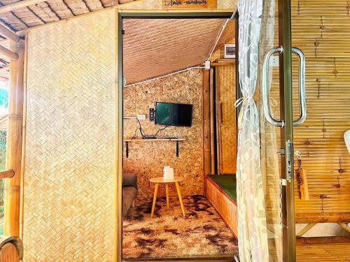 a bathroom with a shower with a table in it at ข้าวทุ่งเบ็ญจาโฮมสเตย์ in Ban Hat Phang