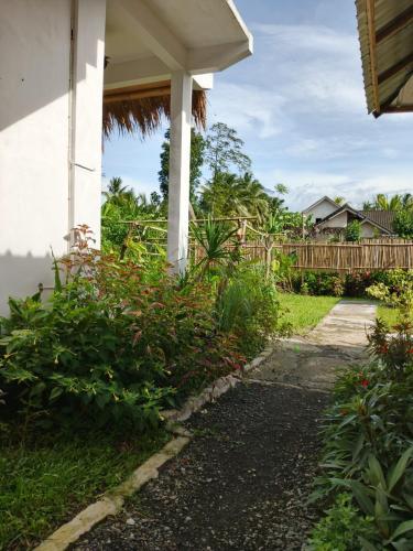 a walkway next to a house with a fence at Stay Together in Tetebatu