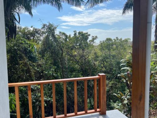 a balcony with a view of the forest at Ocean View Casita Playa Guiones in Nicoya