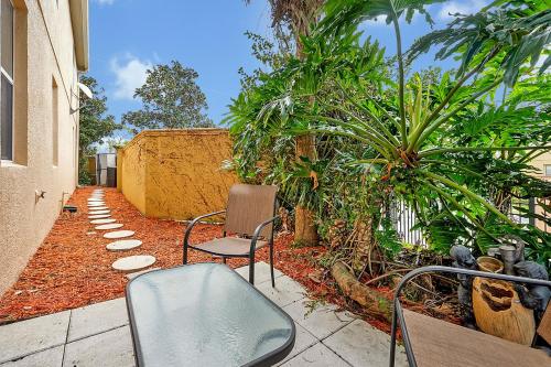 a patio with chairs and trees and a fence at Home Near Disney Private Pool & Playground in Howey in the Hills