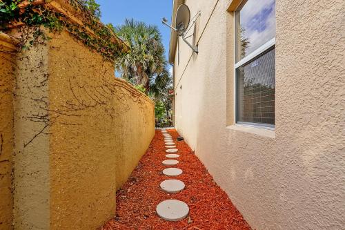 an alley between two buildings with stepping stones between them at Home Near Disney Private Pool & Playground in Howey in the Hills
