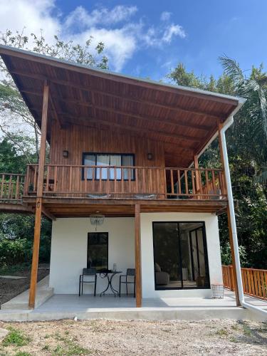 a house with a large deck on top of it at Ocean View Casita Playa Guiones in Nicoya