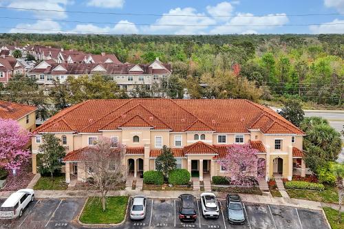 a large house with cars parked in a parking lot at Home Near Disney Private Pool & Playground in Howey in the Hills