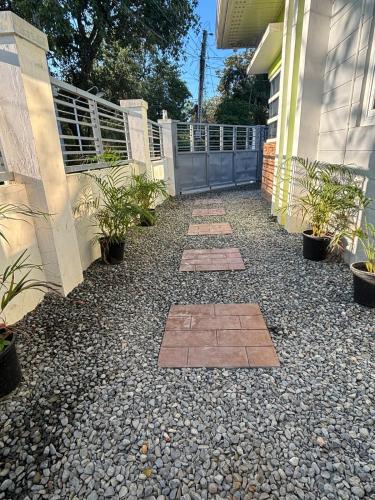 a walkway in front of a house with a fence at Heritage Haven Guesthouse in Vigan