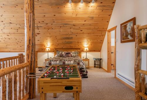 a bedroom with a bed and a pool table at Henrys Post in Island Park