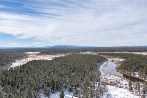 an aerial view of a river in a forest at Henrys Post in Island Park