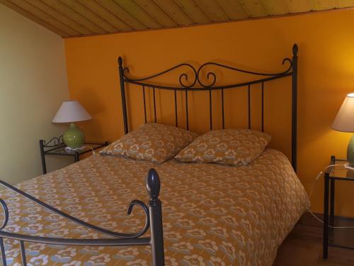 a bedroom with a bed and two lamps at Moulin rénové avec jardin, au bord de l'eau, entre Verdun et Metz - FR-1-585-1 in Bonzée-en-Woëvre