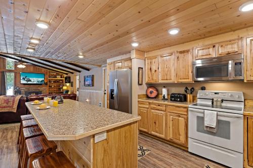 a kitchen with wooden cabinets and a counter top at Huckleberry Hollow in Rea
