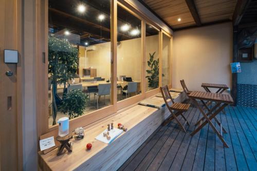 a room with a balcony with chairs and a table at フロント無人管理 コワーキング付き古民家ゲストハウス チェックイン対応不要 in Satogata