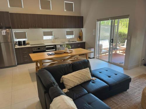 a living room with a blue couch in a kitchen at Villa Sulla Costa at Cape Villas in Dunsborough