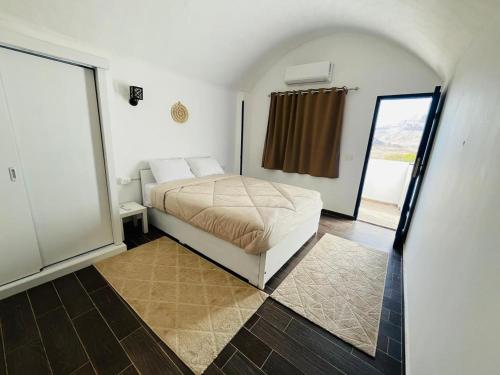 a bedroom with a bed in a room with a window at Sharqotel Luxor in Luxor