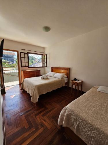 Ένα ή περισσότερα κρεβάτια σε δωμάτιο στο Pousada Portal da Serra