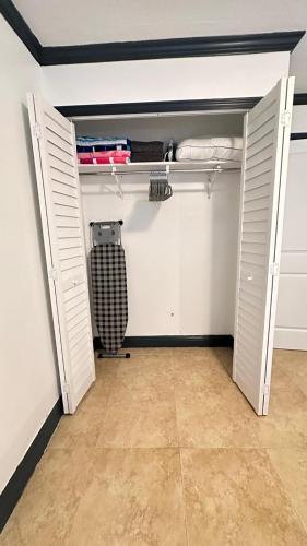 a closet with white walls and white doors at Stylish 1BR Near Miami Airport & Port! in Miami