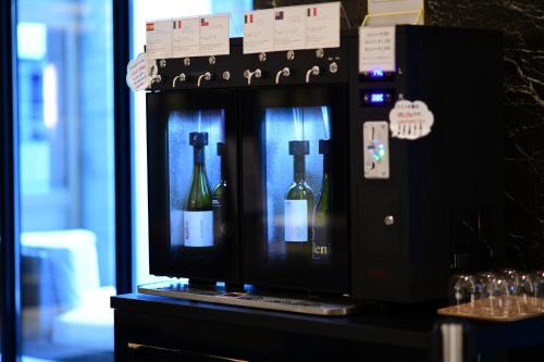 a display of bottles of wine in a machine at The Rise Osaka Kitashinchi in Osaka