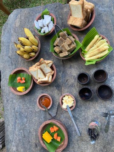 a bunch of food on a table with plates of food at Moonshade Handapanagala in Monaragala