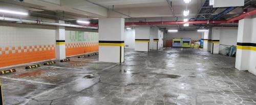 an empty parking garage with a room with yellow and black stripes at Mud Beach Hotel in Boryeong