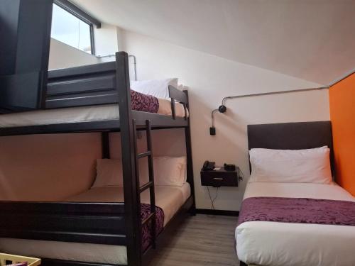a room with two bunk beds and a bed at Posada LA MARIÑERA in Tibasosa