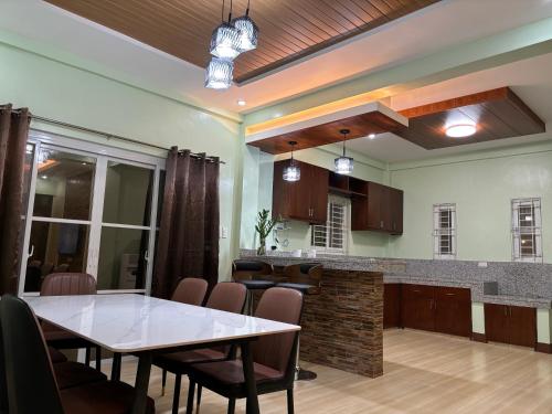 a dining room and kitchen with a table and chairs at Heritage Haven Guesthouse in Vigan