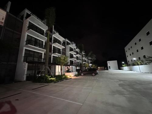 a car parked in a parking lot next to some buildings at Brand New Beachfront Sunset Apartments in San Felipe de Puerto Plata