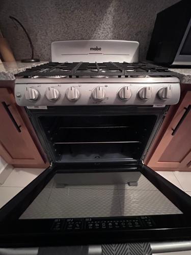 a white stove top oven sitting in a kitchen at Brand New Beachfront Sunset Apartments in San Felipe de Puerto Plata