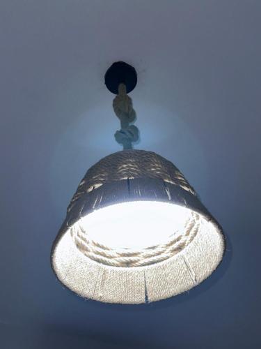 aendant light hanging from a ceiling in a room at Brand New Beachfront Sunset Apartments in San Felipe de Puerto Plata