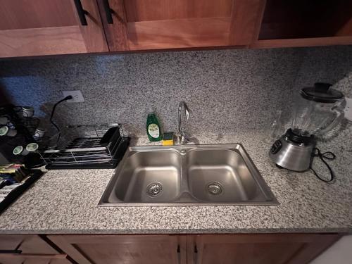 a kitchen counter with a sink and a stove at Brand New Beachfront Sunset Apartments in San Felipe de Puerto Plata