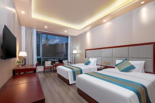 Ένα ή περισσότερα κρεβάτια σε δωμάτιο στο Chenzhou Zhuyuan Hotel