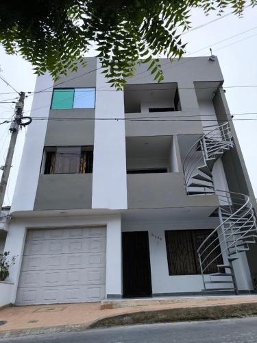 a white apartment building with a fire escape at Apartaestudios la terraza 3 in Sincelejo
