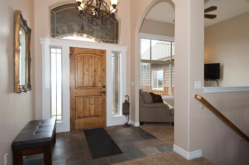 a hallway with a wooden door and a couch at Teton Harmony in Driggs