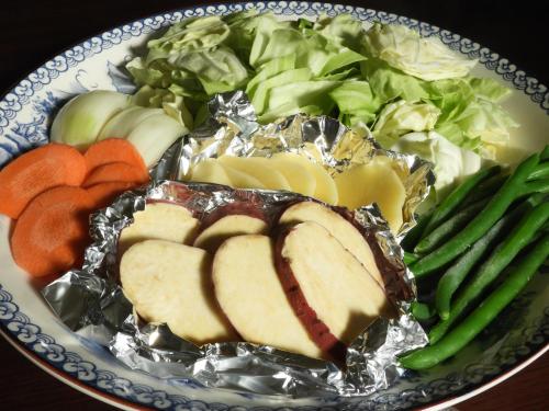 a plate of food with meat and vegetables on it at 一棟貸切の宿 えんの家 in Tsushima