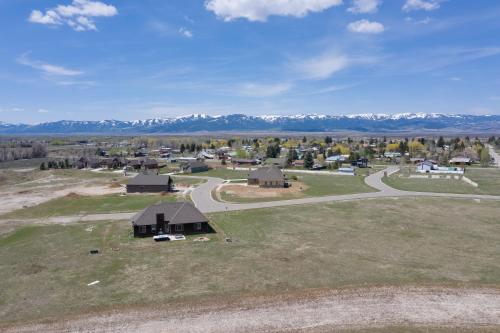 an aerial view of a small village with mountains in the background at Teton Harmony in Driggs