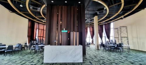 a banquet hall with tables and chairs in a room at Urban Suites George Town in Jelutong