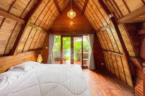 a bedroom with a large bed in a wooden room at The Caldera Villas in Kubupenlokan