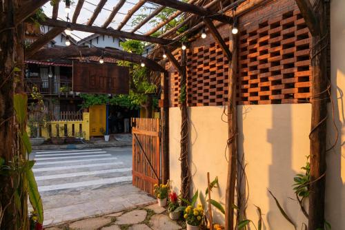 an entrance to a building with a wooden gate at Lamer Coastal Villa in Hoi An
