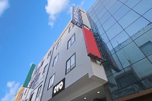 a building with a sign on the side of it at Hotel O Avi Suites in New Delhi