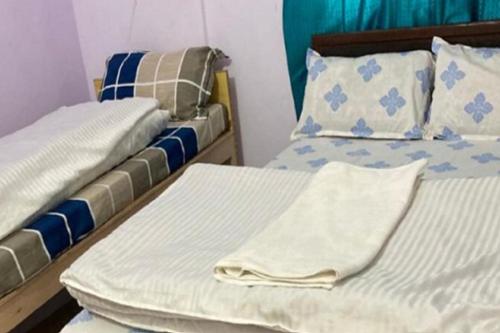 two beds sitting next to each other in a room at Amardeep Homestay by StayApart in Ukhimath