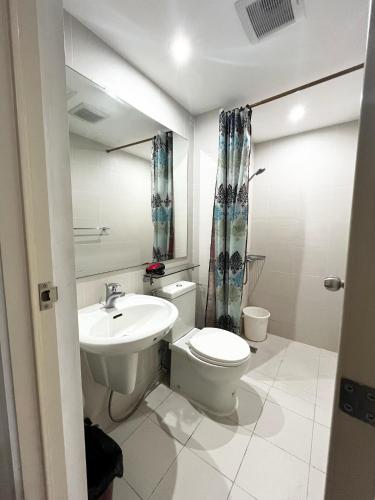 a bathroom with a toilet and a sink at Azure Staycation by Casa Lepap in Manila