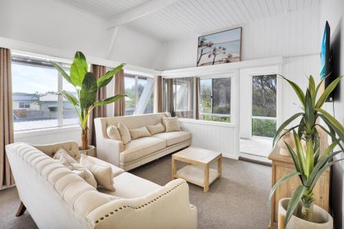 a living room with white furniture and windows at Ingenia Holidays One Mile Beach in One Mile