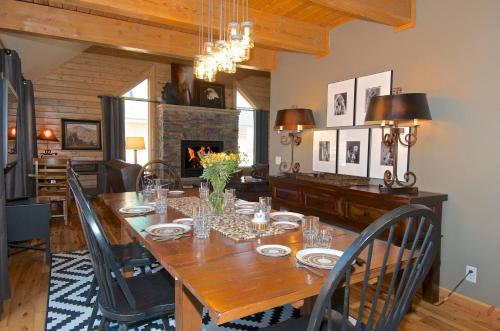 a dining room with a table with chairs and a fireplace at Eagles Perch in Rea
