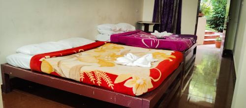a couple of beds with towels on top of them at Magic mountain in Yercaud