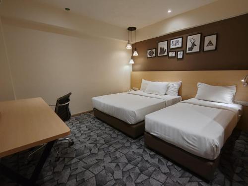Postel nebo postele na pokoji v ubytování Hotel Damai Kuala Lumpur