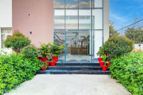a house with a staircase with potted plants at Super Hotel O Gomti Nagar Vigyan khand in Lucknow