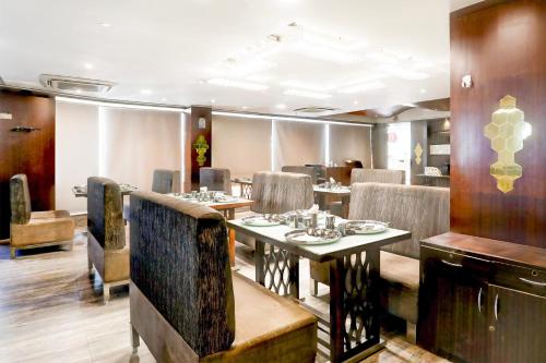 a dining room with a table and chairs at Super Townhouse Prahladnagar in Ahmedabad