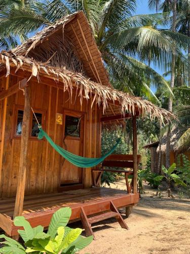 a small hut with a hammock in front of it at Lily's Beach Bungalows in Koh Rong Island